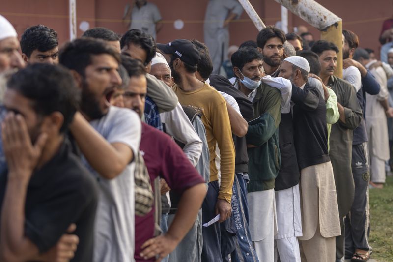 Kashmiri's queue up at a polling booth to cast their vote during the second phase of the assembly election in the outskirts of Srinagar, Indian controlled Kashmir, Wednesday, Sept. 25, 2024. (AP Photo/Dar Yasin)