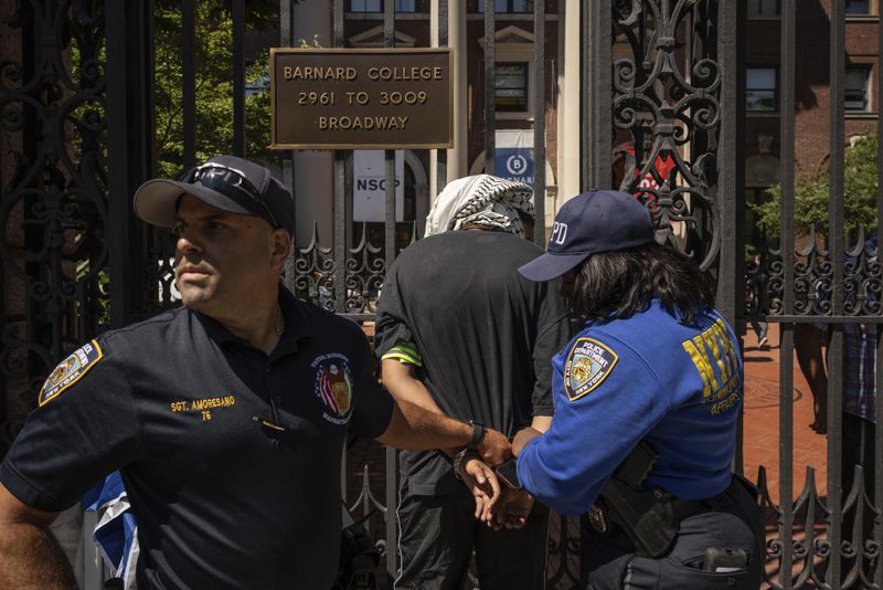 NYPD officers detain a pro-Palestinian supporter as they hold picket line outside Barnard College, Tuesday, Sept. 3, 2024, in New York. (AP Photo/Yuki Iwamura)