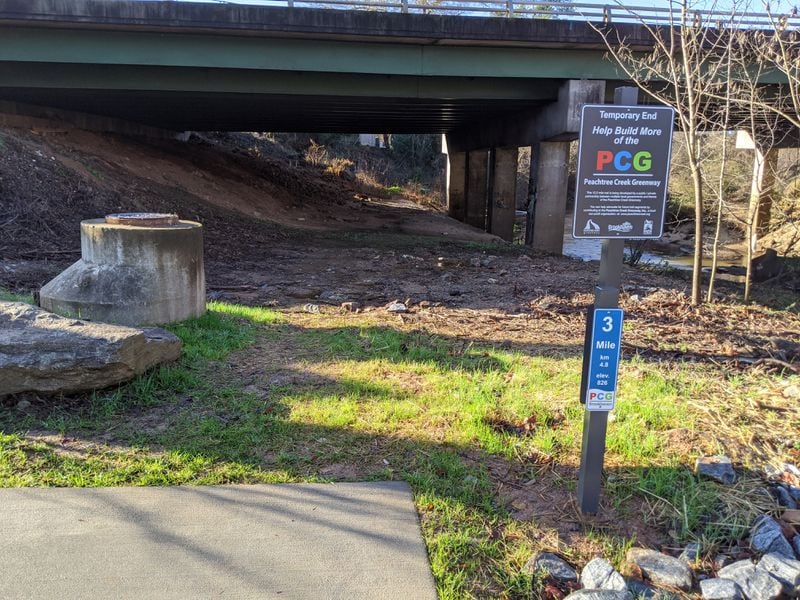 The mile-long stretch of Peachtree Creek Greenway that opened on Dec. 12, 2019, ends under North Druid Hills Road in Brookhaven (pictured Dec. 24, 2019). It could eventually extend to Atlanta’s PATH400, another growing route that could someday connect the Greenway to the Beltline and to Dunwoody and points beyond. TY TAGAMI / TY.TAGAMI@AJC.COM