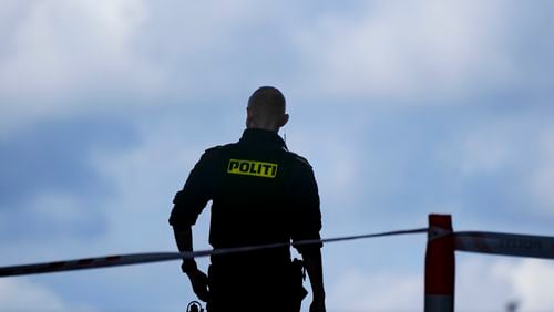 FILE - A police officer stands guard in Copenhagen, Denmark, on July 4, 2022. (AP Photo/Sergei Grits, File)