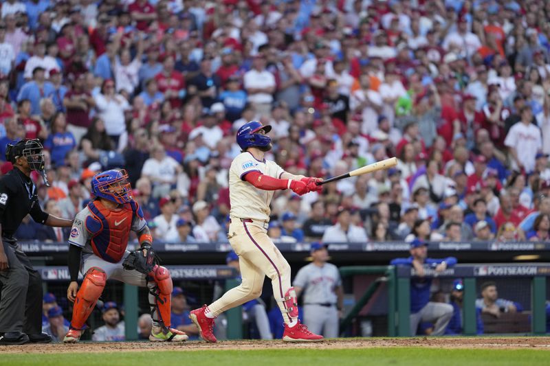 Philadelphia Phillies' Bryce Harper follow through after hitting a two-run home run against New York Mets pitcher Luis Severino during the sixth inning of Game 2 of a baseball NL Division Series, Sunday, Oct. 6, 2024, in Philadelphia. (AP Photo/Matt Slocum)