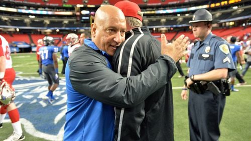 Georgia State Panthers head coach Trent Miles (left) hugs Western Kentucky Hilltoppers head coach Bobby Petrino following the game at the Georgia Dome on Saturday, November 2, 2013. The Hilltoppers won 44-28.