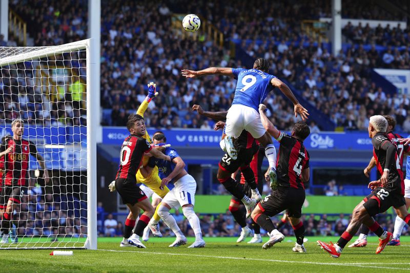 Everton's Dominic Calvert-Lewin, center, heads the ball during the English Premier League soccer match between Everton and Bournemouth at Goodison Park, Liverpool, England, Saturday Aug. 31, 2024. (Peter Byrne/PA via AP)