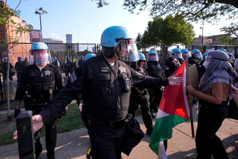 Police direct protesters at the United Center after a march at the Democratic National Convention Monday, Aug. 19, 2024, in Chicago. (AP Photo/Alex Brandon)