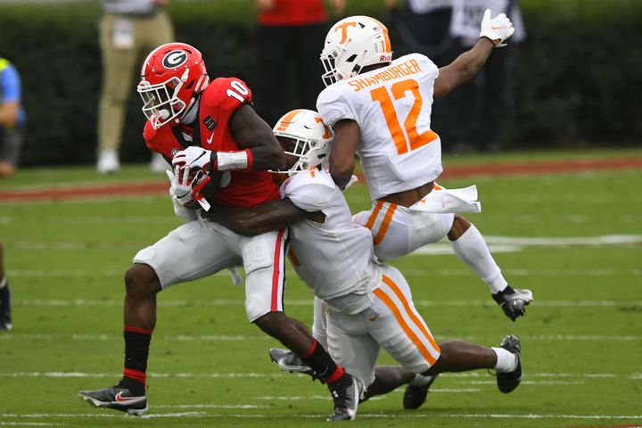 Georgia wide receiver Kearis Jackson (10) makes a catch as Tennessee defensive back Trevon Flowers (1) and defensive back Shawn Shamburger (12) defend during the first half of a football game Saturday, Oct. 10, 2020, at Sanford Stadium in Athens. JOHN AMIS FOR THE ATLANTA JOURNAL- CONSTITUTION