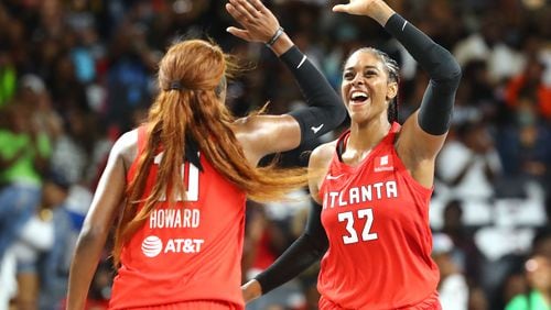 Atlanta Dream guard Rhyne Howard (left) and forward Cheyenne Parker helped lead the team to a home victory Sunday against the Storm. (Curtis Compton / Curtis.Compton@ajc.com)