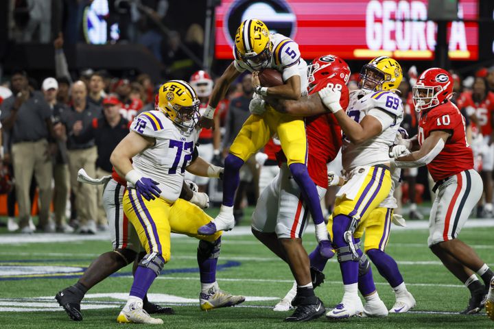 LSU Tigers quarterback Jayden Daniels (5) is stopped by Georgia Bulldogs defensive lineman Jalen Carter (88) during the second half of the SEC Championship Game at Mercedes-Benz Stadium in Atlanta on Saturday, Dec. 3, 2022. (Bob Andres / Bob Andres for the Atlanta Constitution)
