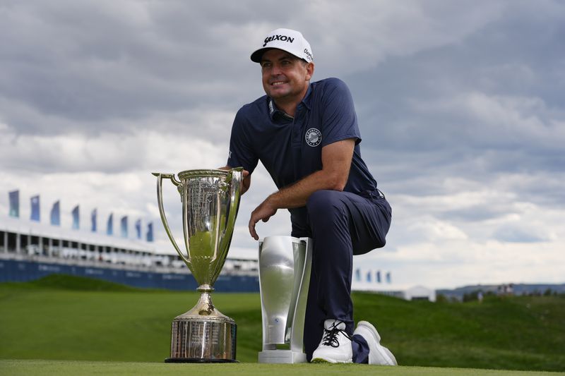 Keegan Bradley poses with the BMW Championship and J.K. Wadley trophies after winning the BMW Championship golf event at Castle Pines Golf Club, Sunday, Aug. 25, 2024, in Castle Rock, Colo. (AP Photo/Matt York)