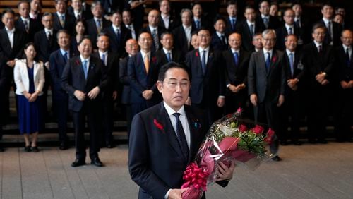 Japan's outgoing Prime Minister Fumio Kishida, center, speaks as he leaves the prime minister's office in Tokyo Tuesday, Oct. 1, 2024. (AP Photo/Hiro Komae)