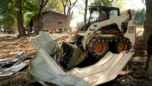 Debris left in the aftermath of Hurricane Helene is cleared Saturday, Oct. 5, 2024, in Del Rio, Tenn. (AP Photo/Jeff Roberson)