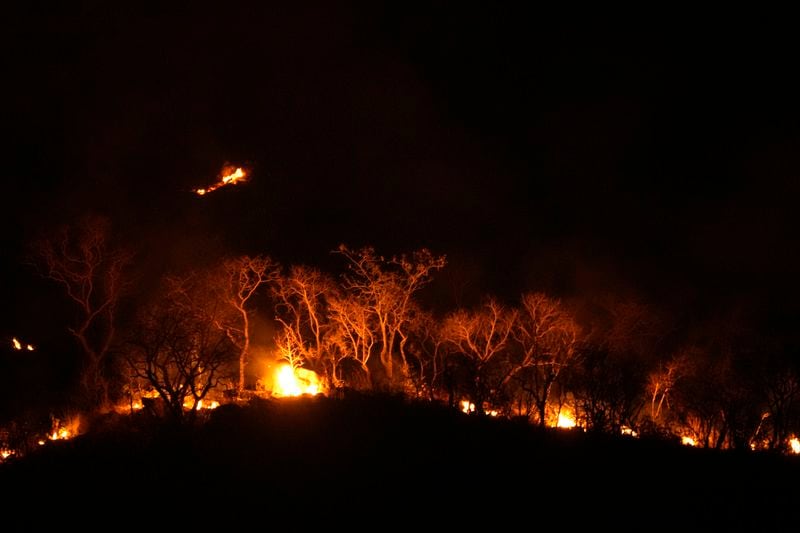 Fires spread through the environmental protection area of Pouso Alto, in Chapada dos Veadeiros National Park, during dry season, in Minas Sul, Goias state, Brazil, Monday, Sept. 9, 2024. (AP Photo/Eraldo Peres)