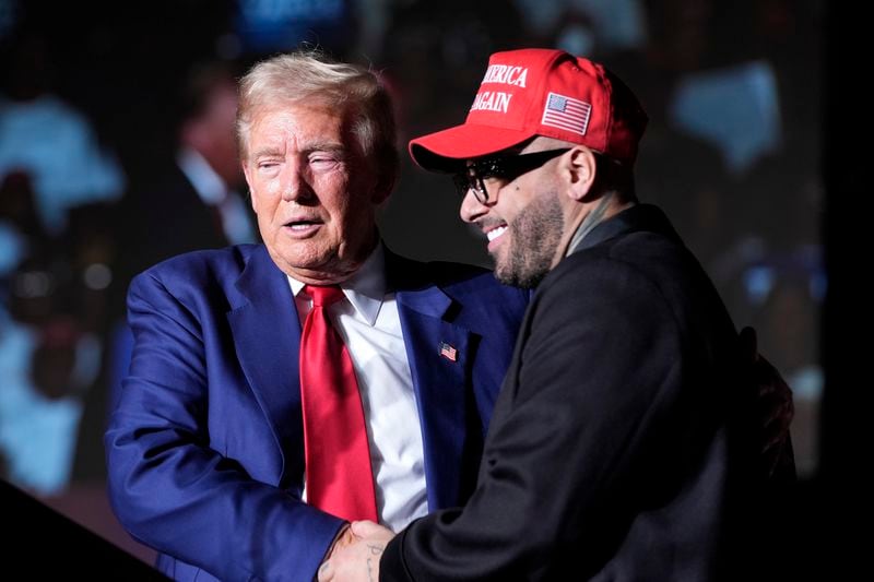 Republican presidential nominee former President Donald Trump, left, greets Nicky Jam during a campaign event at the World Market Center, Friday, Sept.13, 2024, in Las Vegas. (AP Photo/Alex Brandon)