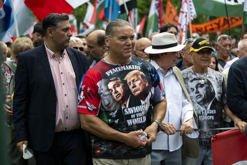 FILE -A man wearing a T-shirt showing Viktor Orban and Donald Trump, attends a "peace march" in support of Prime Minister Viktor Orbán and his party in Budapest, Hungary on June 1, 2024. (AP Photo/Denes Erdos, File)