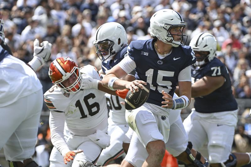 Penn State quarterback Drew Allar (15) scrambles away from Bowling Green defensive lineman Chace Davis (16) during the first quarter of an NCAA college football game, Saturday, Sept. 7, 2024, in State College, Pa. (AP Photo/Barry Reeger)