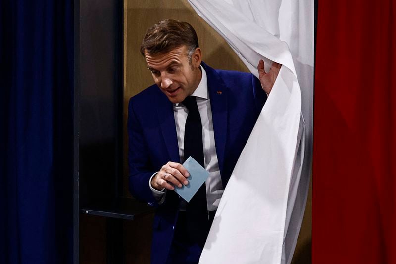 French President Emmanuel Macron leaves the voting booth before voting in Le Touquet-Paris-Plage, northern France, Sunday, June 30, 2024. France is holding the first round of an early parliamentary election that could bring the country's first far-right government since Nazi occupation during World War II. The second round is on July 7, and the outcome of the vote remains highly uncertain (Yara Nardi, Pool via AP)