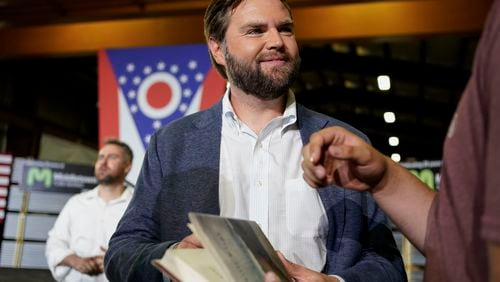 FILE - J.D. Vance, the venture capitalist and author of "Hillbilly Elegy," holds his book as he speaks with supporters after a rally on July 1, 2021, in Middletown, Ohio, where he announced he is joining the crowded Republican race for the Ohio U.S. Senate seat. Sen. Vance, R-Ohio, sharply criticized Donald Trump during the 2016 election cycle, before changing course and embracing the former president. Vance is now one of Trump's fiercest allies and defenders and among those short-listed to be Trump's vice presidential pick. (AP Photo/Jeff Dean, File)