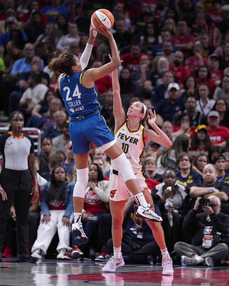 Minnesota Lynx forward Napheesa Collier (24) shoots over Indiana Fever defender Lexie Hull (10) during the second half of a WNBA basketball game in Indianapolis, Friday, Sept. 6, 2024. (AP Photo/Michael Conroy)