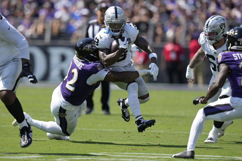 Baltimore Ravens defensive tackle Nnamdi Madubuike (92) tackles Las Vegas Raiders running back Ameer Abdullah (8) during the first half of an NFL football game, Sunday, Sept. 15, 2024, in Baltimore. (AP Photo/Stephanie Scarbrough)