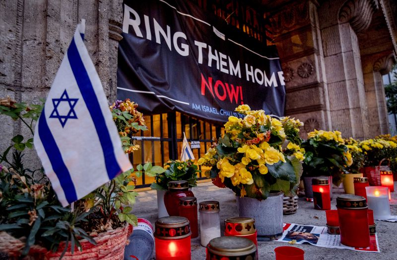 Candles and flowers are laid at the entrance of the synagogue to mark the first anniversary of the Hamas attack on Israel, Frankfurt, Germany, Monday, Oct. 7, 2024. (AP Photo/Michael Probst)