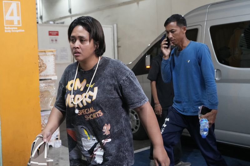 Family members of a victim arrive at a forensic police hospital in Bangkok, Thailand, Wednesday, Oct. 2, 2024. (AP Photo/Sakchai Lalit)