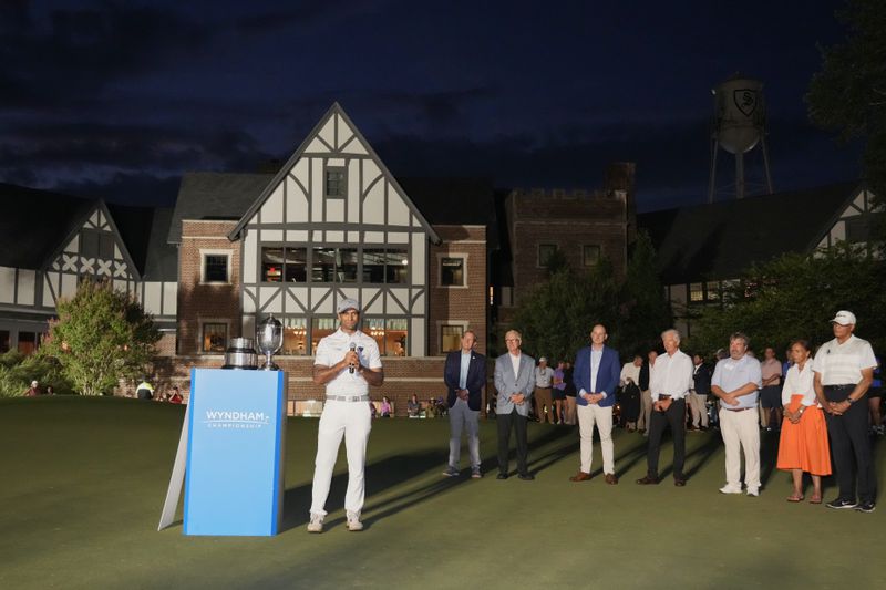 Aaron Rai, of England, center, speaks during the award ceremony after winning the Wyndham Championship golf tournament in Greensboro, N.C., Sunday, Aug. 11, 2024. (AP Photo/Chuck Burton)