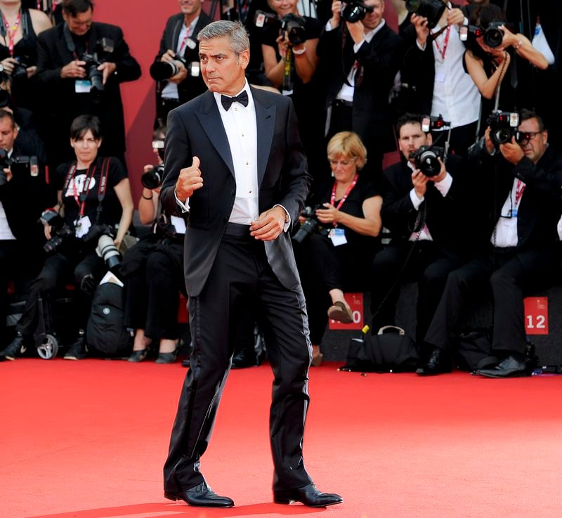 FILE - US actor George Clooney arrives on the red carpet for the premiere of his movie "The Ides of March," opening the 68th edition of the Venice Film Festival in Venice, Italy on Aug. 31, 2011. (AP Photo/Jonathan Short, File)