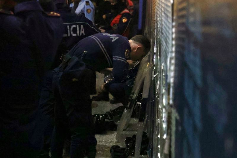 An Albania police man washes his face during an anti-government rally set up by the opposition, in Tirana, Albania, Monday, Oct. 7, 2024. (AP Photo/Hameraldi Agolli)