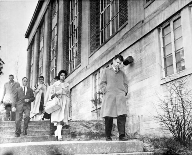 Charlayne Hunter, the first of two African American students admitted to UGA, is escorted to class by university officials on Jan. 16, 1961, in Athens. (Bill Young / AJC Archive at GSU Library AJCP551-061n)
