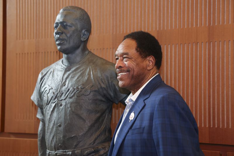 Hall of Fame outfielder Dave Winfield gets his photograph taken next to the Hank Aaron statue by the grand staircase at the National Baseball Hall of Fame, Thursday, May 23, 2024, in Cooperstown, NY. (Jason Getz / AJC)
