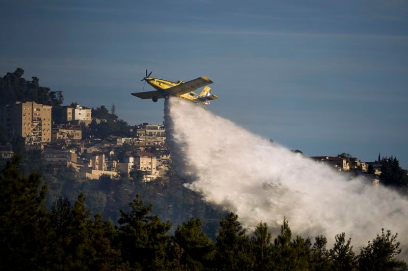 An Israeli firefighters plane uses a fire retardant to extinguish a fire after a rocket fired from Lebanon hit an open area near the city of Safed, northern Israel, on Saturday, Sept. 21, 2024. (AP Photo/Leo Correa)