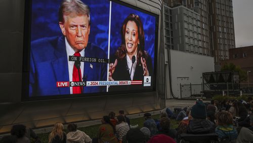 People watch a presidential debate between Republican presidential nominee former President Donald Trump and Democratic presidential nominee Vice President Kamala Harris at the Berkeley Art Museum and Pacific Film Archive watch party in Berkeley, Calif., Tuesday, Sept. 10, 2024. (Gabrielle Lurie/San Francisco Chronicle via AP)