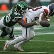 New York Jets linebacker Quincy Williams (56) knocks the ball loose for a fumble by Denver Broncos running back Tyler Badie (28) during the first quarter of an NFL football game, Sunday, Sept. 29, 2024, in East Rutherford, N.J. (AP Photo/Bryan Woolston)