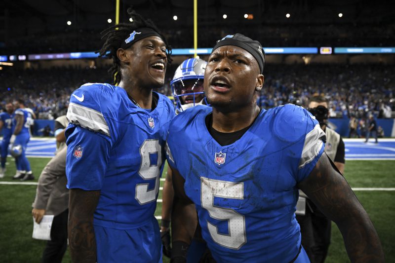 Detroit Lions running back David Montgomery (5). celebrates his one-yard touchdown run with Jameson Williams (9) against the Los Angeles Rams during overtime in an NFL football game in Detroit, Sunday, Sept. 8, 2024. (AP Photo/David Dermer)