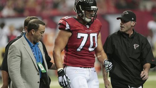 Atlanta Falcons offensive tackle Jake Matthews (70) walks off the field after being injured against the New Orleans Saints during the first half of an NFL football game, Sunday, Sept. 7, 2014, in Atlanta. (AP Photo/John Bazemore)