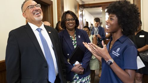U.S. Secretary of Education Miguel Cardona laughs while listening to rising sophomore Kennedy Rogers during a tour of Spelman College in Atlanta on Wednesday, July 17, 2024. (Ben Gray / Ben@BenGray.com)