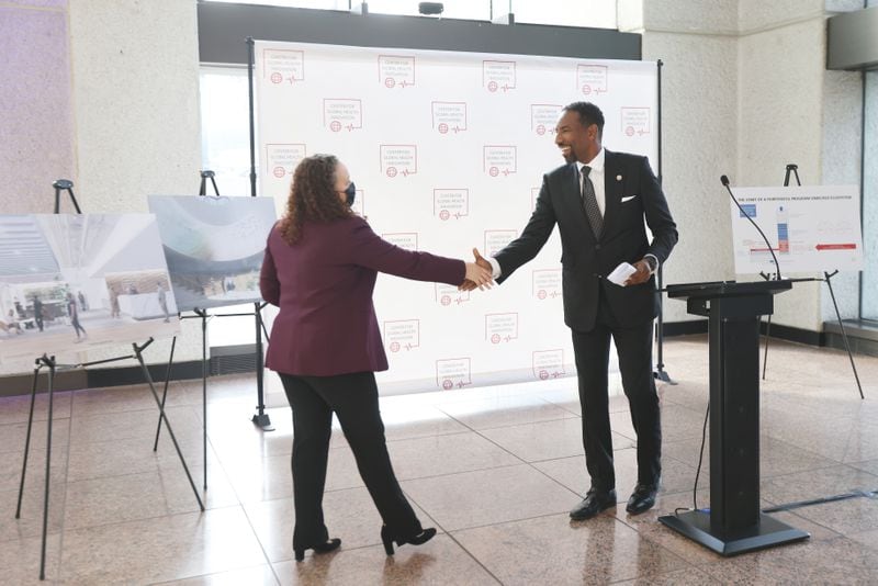 After his press conference, City of Atlanta mayor-elect Andre Dickens congratulates Maria Thacker Goethe, CEO of Center for Global Health Innovation. Wednesday, December 15, 2021. Miguel Martinez for The Atlanta Journal-Constitution 
