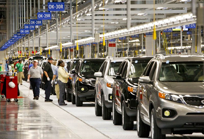 Kia Sorento vehicles travel along the assembly line in a Kia automobile manufacturing facility in West Point. {Kia Motors via Bloomberg)