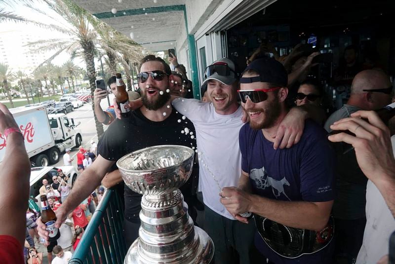 Florida Panthers NHL hockey players, from left, Anthony Stolarz, Sam Bennett and Matthew Tkachuk sing "We Are The Champions" as they celebrate winning the the Stanley Cup at the Elbo Room in Fort Lauderdale, Fla., Tuesday, June 25, 2024. The Panthers beat the Edmonton Oilers 2-1 on Monday night in Game 7 of the Stanley Cup Final. (Joe Cavaretta/South Florida Sun-Sentinel via AP)