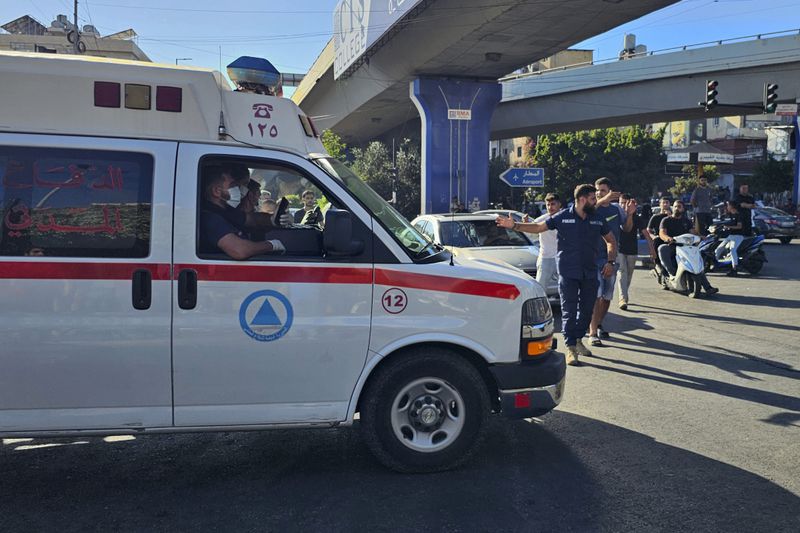 An ambulance carries wounded people whose handheld pager exploded, in Beirut, Lebanon, Tuesday, Sept. 17, 2024. (AP Photo/Hassan Ammar)