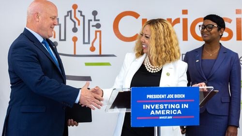 (L-R) Mitch Landrieu, senior advisor to President Joe Biden, and U.S. Rep. Lucy McBath shake hands during a press conference on regional transportation and infrastructure at the Curiosity Lab in Peachtree Corners on Tuesday, August 29, 2023. (Arvin Temkar / arvin.temkar@ajc.com)