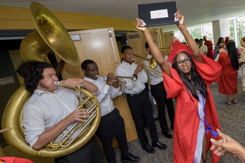 Skyy Stevenson dances to the music of the One Up Brass Band after receiving her high school equivalency (HiSET) diploma during a graduation ceremony for the Youth Empowerment Project (YEP) a non-profit organization in New Orleans, Thursday, June 27, 2024. (AP Photo/Matthew Hinton)