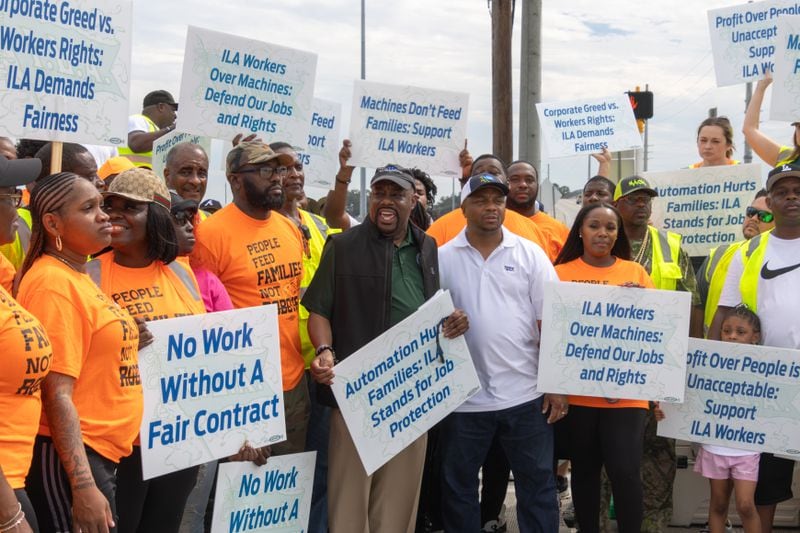 Savannah Mayor Van R. Johnson (in green shirt) joins dockworkers while on strike in Garden City on Tuesday.