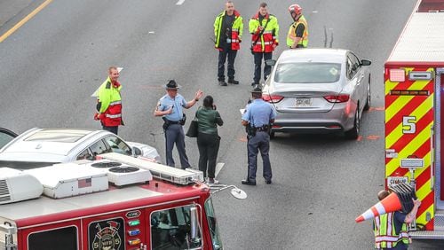 Troopers with the Georgia State Patrol work the scene of a pedestrian crash Tuesday morning on I-75 South near Marietta. The pedestrian was taken to a hospital with critical injuries.
