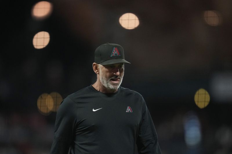 Arizona Diamondbacks manager Torey Lovullo walks to the dugout after making a pitching change during the seventh inning of a baseball game against the San Francisco Giants in San Francisco, Tuesday, Sept. 3, 2024. (AP Photo/Jeff Chiu)