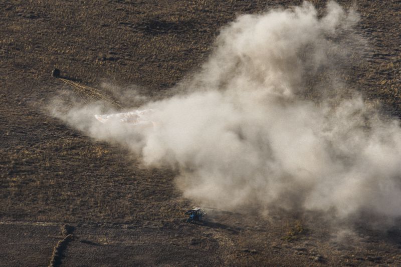 In this photo released by Roscosmos space corporation, a tractor is seen in the foreground at the site of landing of Russian Soyuz MS-25 space capsule carrying NASA astronaut Tracy Dyson, Roscosmos cosmonauts Oleg Kononenko and Nikolai Chub, south-east of the Kazakh town of Zhezkazgan, Kazakhstan, Monday, Sept. 23, 2024. (Ivan Timoshenko, Roscosmos space corporation via AP)