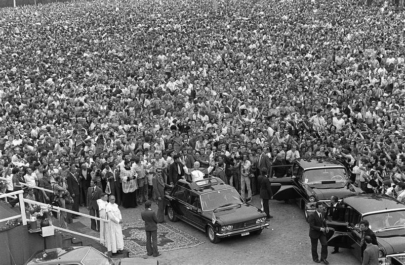 FILE - Pope John Paul II stands in his car as hundreds of thousands of people bid him farewell beneath the Jasna Gora monastery in Czestochowa, Poland, on June 6, 1979. The Pope was greeted by wildly enthusiastic crowds on his first visit to his homeland as leader of the Catholic faith. (AP Photo, File)