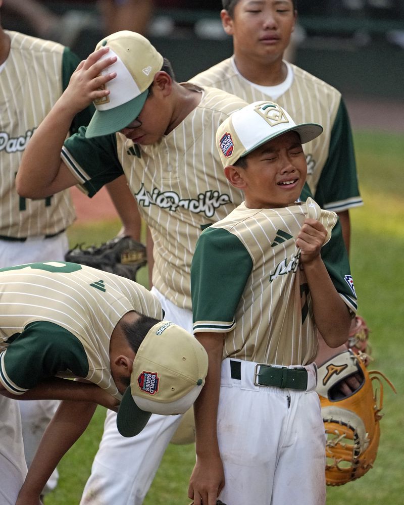 Members of the Taiwan team react after losing the Little League World Series Championship game to Lake Mary, Fla., in South Williamsport, Pa., Sunday, Aug. 25, 2024. (AP Photo/Gene J. Puskar)