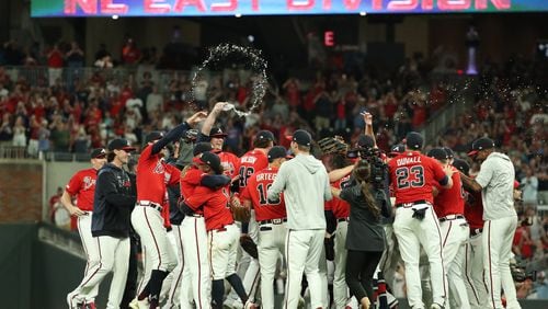 Atlanta Braves players celebrate their 6-0 win against the San Francisco Giants to clinch the NL East division at Sun Trust Park Friday, September 20, 2019 in Atlanta. (JASON GETZ/SPECIAL TO THE AJC)