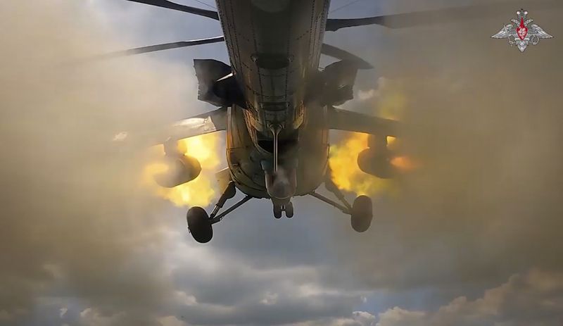 In this photo taken from video released by the Russian Defense Ministry on Wednesday, Aug. 21, 2024, Russian Mi-35M helicopter fires towards Ukrainian positions at an undisclosed location in the Russian - Ukrainian border area in the Kursk region, Russia. (Russian Defense Ministry Press Service photo via AP)