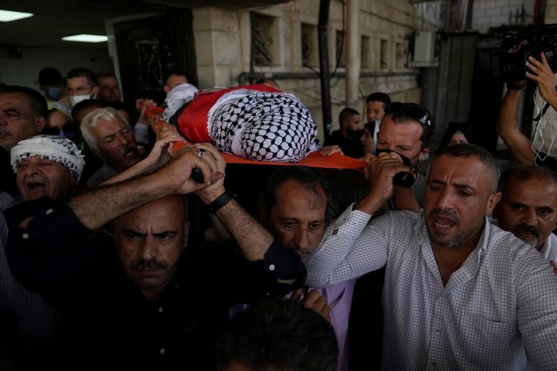 Mourners carry the body of Aysenur Ezgi Eygi, 26, who was fatally shot by Israeli soldiers while participating in an anti-settlement protest in the West Bank, during her funeral procession in the West Bank city of Nablus, Monday, Sept. 9, 2024. (AP Photo/Nasser Nasser)